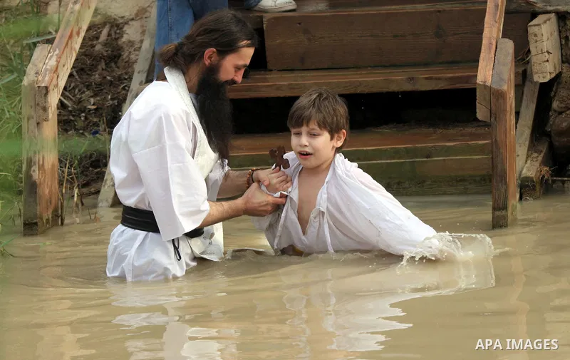 Christian Orthodox pilgrims attend a traditional Epiphany ceremony, at the baptismal site of Qasr el Yahud, the spot where John the Baptist is said to have baptized Jesus, near the West Bank town of Jericho, Tuesday, Jan...