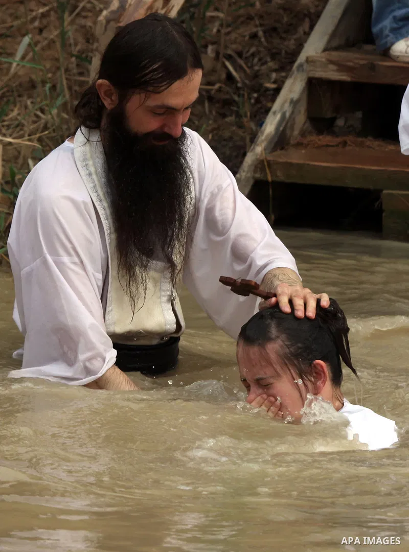 Christian Orthodox pilgrims attend a traditional Epiphany ceremony, at the baptismal site of Qasr el Yahud, the spot where John the Baptist is said to have baptized Jesus, near the West Bank town of Jericho, Tuesday, Jan...