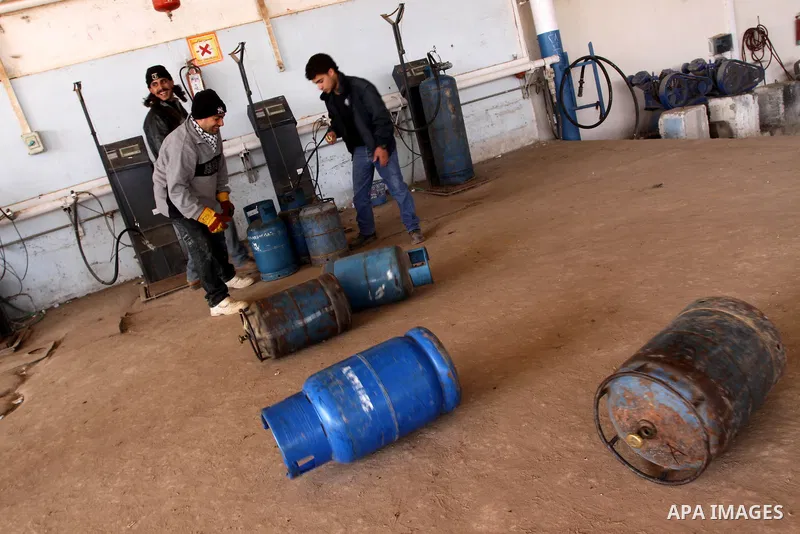 Palestinian workers fill an empty cylinders at a gas station in Gaza City, Jan. 19, 2011. Local officials said that the consumption of cooking gas mainly in houses, bakeries, hospitals, restaurants and farms during winte...