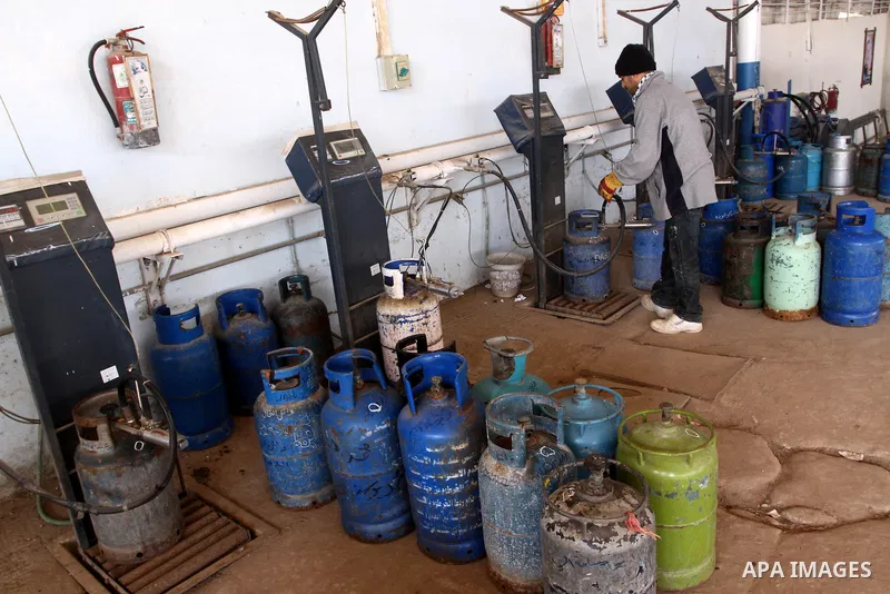 A Palestinian worker fills an empty cylinders at a gas station in Gaza City, Jan. 19, 2011. Local officials said that the consumption of cooking gas mainly in houses, bakeries, hospitals, restaurants and farms during win...