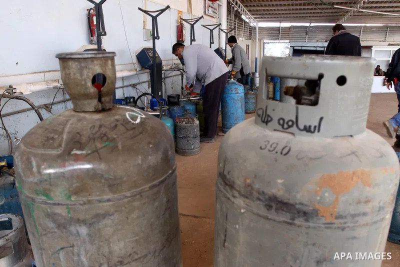 Palestinian workers fill an empty cylinders at a gas station in Gaza City, Jan. 19, 2011. Local officials said that the consumption of cooking gas mainly in houses, bakeries, hospitals, restaurants and farms during winte...
