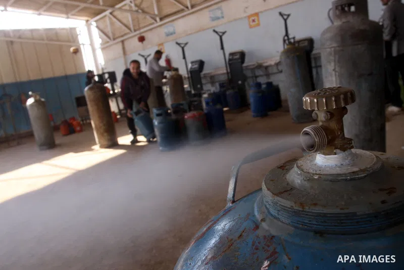 Palestinian workers fill an empty cylinders at a gas station in Gaza City, Jan. 19, 2011. Local officials said that the consumption of cooking gas mainly in houses, bakeries, hospitals, restaurants and farms during winte...