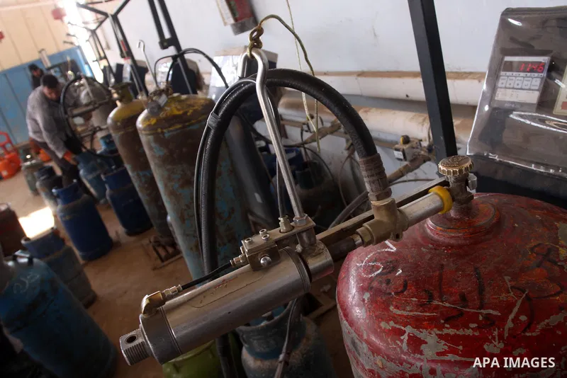 Palestinian workers fill an empty cylinders at a gas station in Gaza City, Jan. 19, 2011. Local officials said that the consumption of cooking gas mainly in houses, bakeries, hospitals, restaurants and farms during winte...