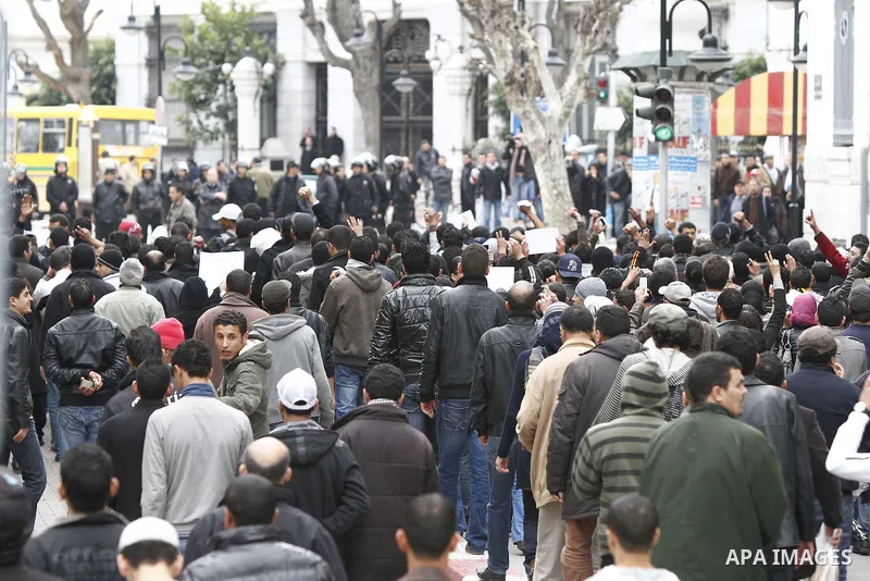 Tunisians take part in a demonstration against Tunisia's ruling Constitutional Democratic Rally party (RCD) in the center of Tunis, Jan. 18. 2011. Tunisian interim president Foued Mebazaa and Prime Minister Mohammed Ghan...
