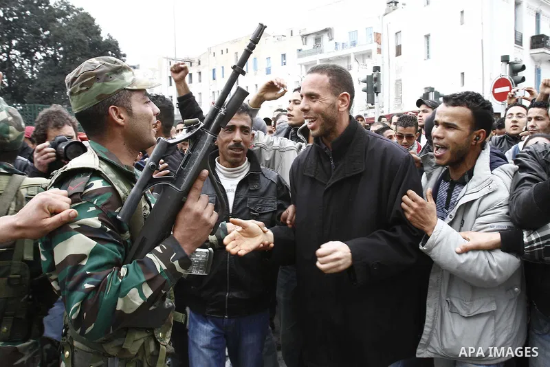 Tunisians take part in a demonstration against Tunisia's ruling Constitutional Democratic Rally party (RCD) in the center of Tunis, Jan. 18. 2011. Tunisian interim president Foued Mebazaa and Prime Minister Mohammed Ghan...