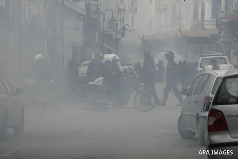 Tunisians run away as police use tear gas during a demonstration against Tunisia's ruling Constitutional Democratic Rally party (RCD) in the center of Tunis, Jan. 18. 2011. Tunisian interim president Foued Mebazaa and Pr...