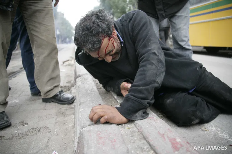 A protestor is injured during a demonstration in downtown Tunis Jan. 18, 2010. Thousands of Tunisians flood the streets in downtown Tunis protesting against the interim government only one day after it was established. P...