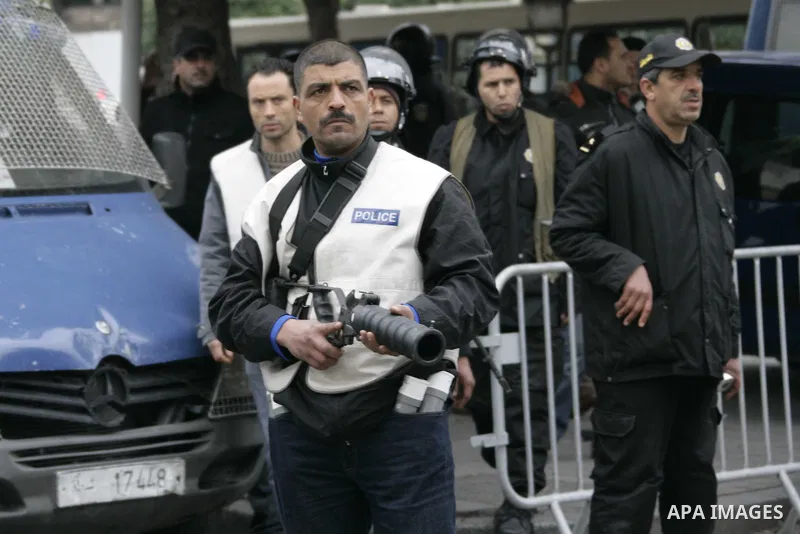 Riot police officers uses tear gas after a demonstration against Constitutional Democratic Rally, RCD, party of Ben Ali in the center of Tunis, Tuesday, Jan. 18. 2011. Four ministers quit Tunisia's day-old government on...