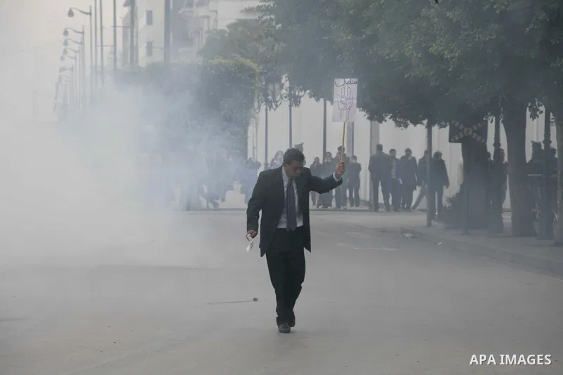 Tunisian demonstrators hold signs during a demonstration in downtown Tunis January 18, 2011.protests still going on in Tunis 4 days after the Depature of the Tunisian President Zine El Abidine Ben Ali to Saudi Arabia, Tu...
