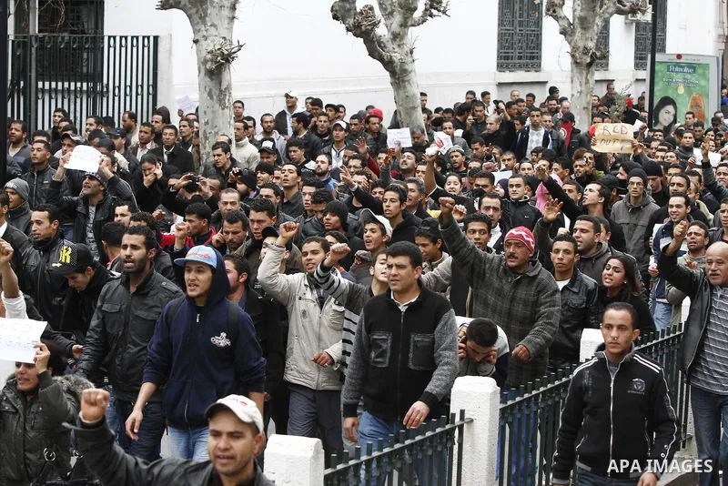 Tunisians take part in a demonstration against Tunisia's ruling Constitutional Democratic Rally party (RCD) in the center of Tunis, Jan. 18. 2011. Tunisian interim president Foued Mebazaa and Prime Minister Mohammed Ghan...