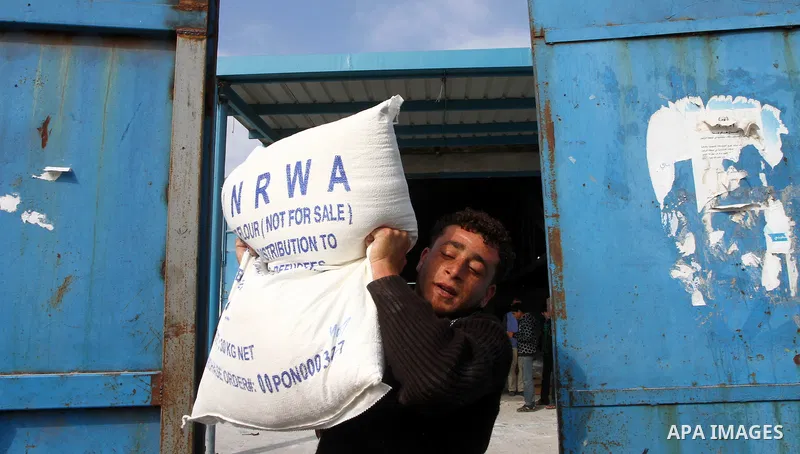 Palestinians receive aid flour sacks from a UN Relief and Works Agency (UNRWA) warehouse in Gaza city, on Jan. 19, 2011. Photo by Ashraf Amra