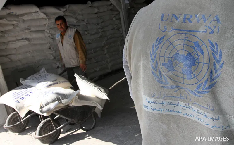 Palestinians receive aid flour sacks from a UN Relief and Works Agency (UNRWA) warehouse in Gaza city, on Jan. 19, 2011. Photo by Ashraf Amra