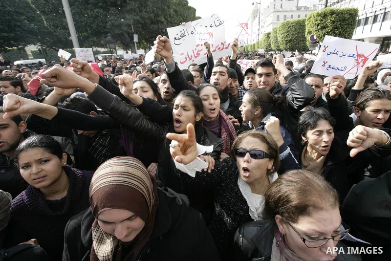Tunisians take part in a protest calling the former ruling party the Constitutional Democratic Rally (RCD) to withdraw from the newly formed interim government in Tunis, Tunisia, 19 January 2011. Tunisia's transitional g...