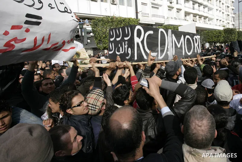 Tunisians take part in a protest calling the former ruling party the Constitutional Democratic Rally (RCD) to withdraw from the newly formed interim government in Tunis, Tunisia, 19 January 2011. Tunisia's transitional g...