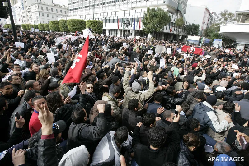 Tunisians take part in a protest calling the former ruling party the Constitutional Democratic Rally (RCD) to withdraw from the newly formed interim government in Tunis, Tunisia, 19 January 2011. Tunisia's transitional g...