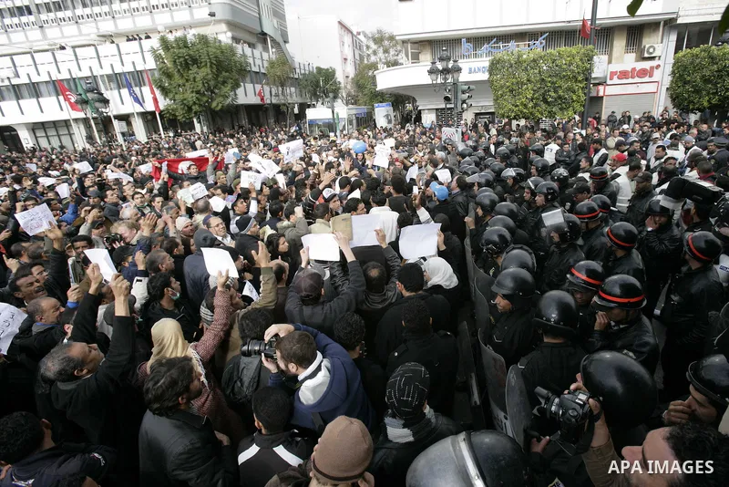 Tunisians take part in a protest calling the former ruling party the Constitutional Democratic Rally (RCD) to withdraw from the newly formed interim government in Tunis, Tunisia, 19 January 2011. Tunisia's transitional g...