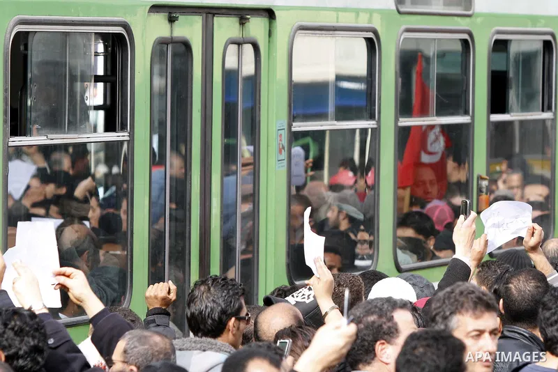 Tunisians take part in a protest calling the former ruling party the Constitutional Democratic Rally (RCD) to withdraw from the newly formed interim government in Tunis, Tunisia, 19 January 2011. Tunisia's transitional g...