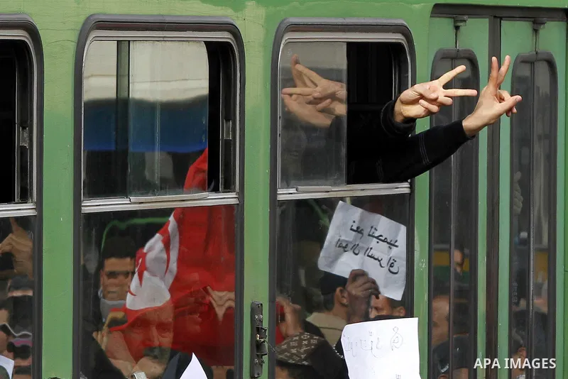 Tunisians take part in a protest calling the former ruling party the Constitutional Democratic Rally (RCD) to withdraw from the newly formed interim government in Tunis, Tunisia, 19 January 2011. Tunisia's transitional g...