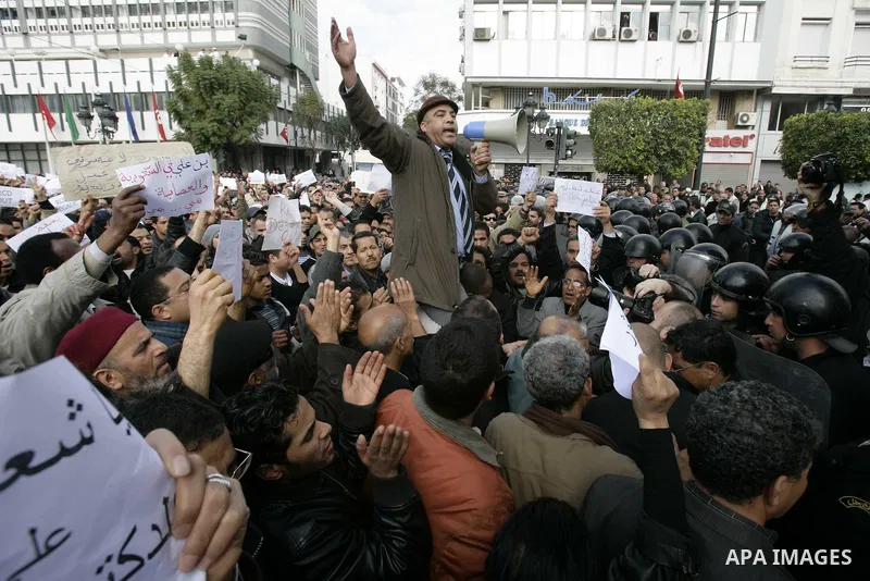 Tunisians take part in a protest calling the former ruling party the Constitutional Democratic Rally (RCD) to withdraw from the newly formed interim government in Tunis, Tunisia, 19 January 2011. Tunisia's transitional g...