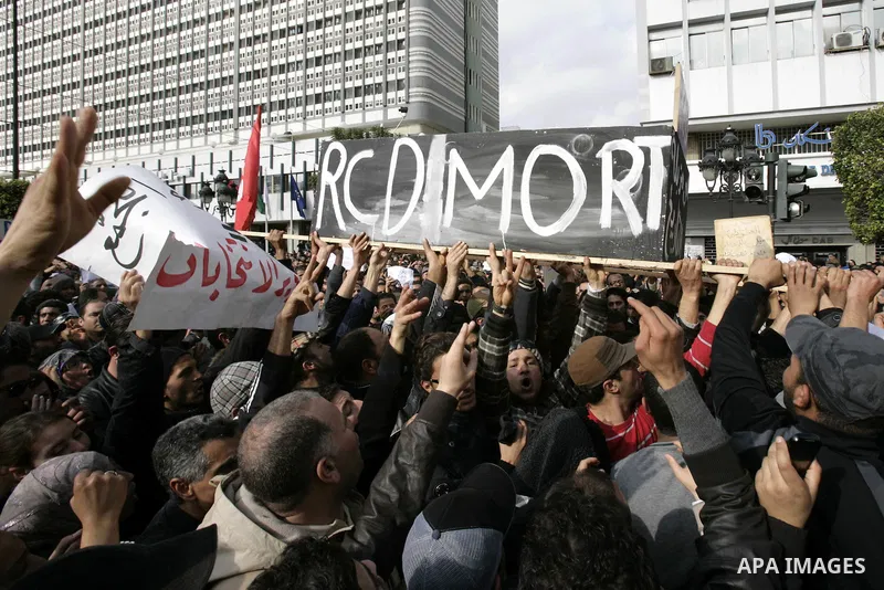 Tunisians take part in a protest calling the former ruling party the Constitutional Democratic Rally (RCD) to withdraw from the newly formed interim government in Tunis, Tunisia, 19 January 2011. Tunisia's transitional g...