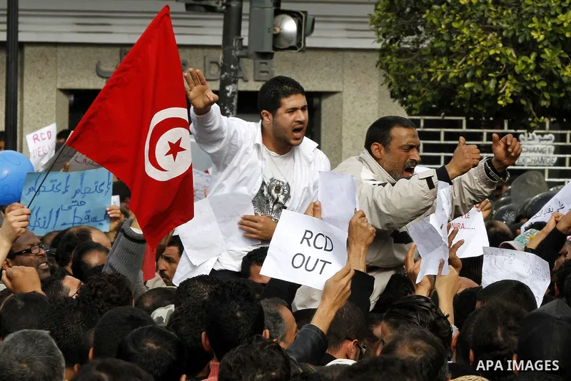 Tunisians take part in a protest calling the former ruling party the Constitutional Democratic Rally (RCD) to withdraw from the newly formed interim government in Tunis, Tunisia, 19 January 2011. Tunisia's transitional g...