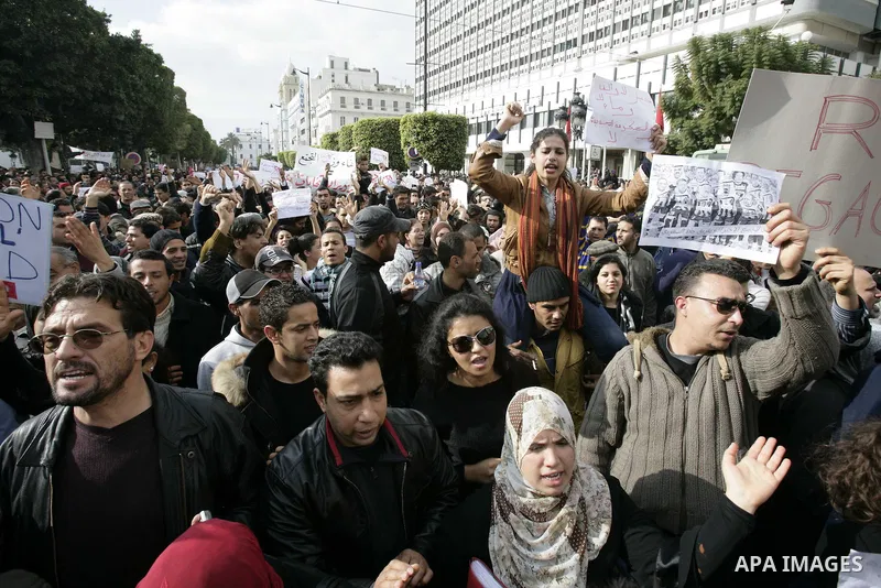 Tunisians take part in a protest calling the former ruling party the Constitutional Democratic Rally (RCD) to withdraw from the newly formed interim government in Tunis, Tunisia, 19 January 2011. Tunisia's transitional g...