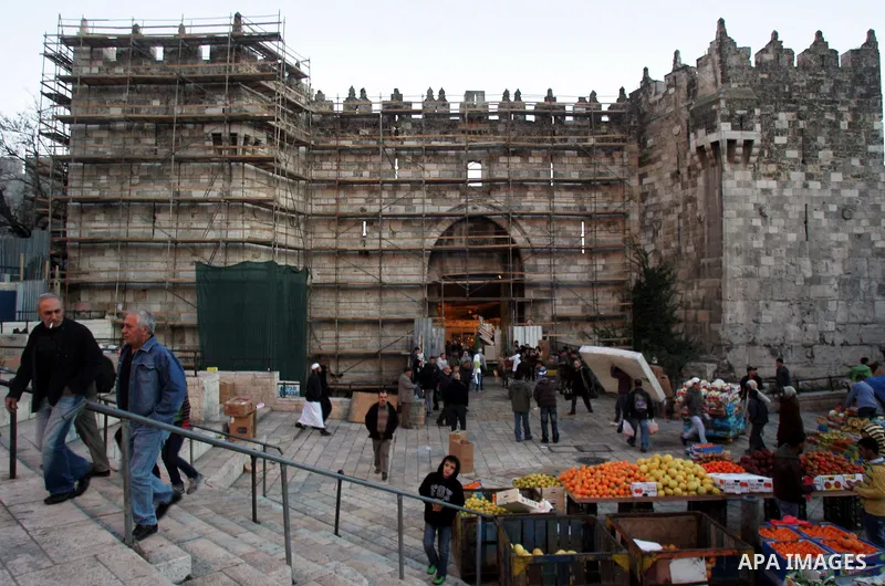Palestinians walk near the restoration work in the old city wall of Jerusalem on Jan. 19,2011. Photo by Mahfouz Abu Turk