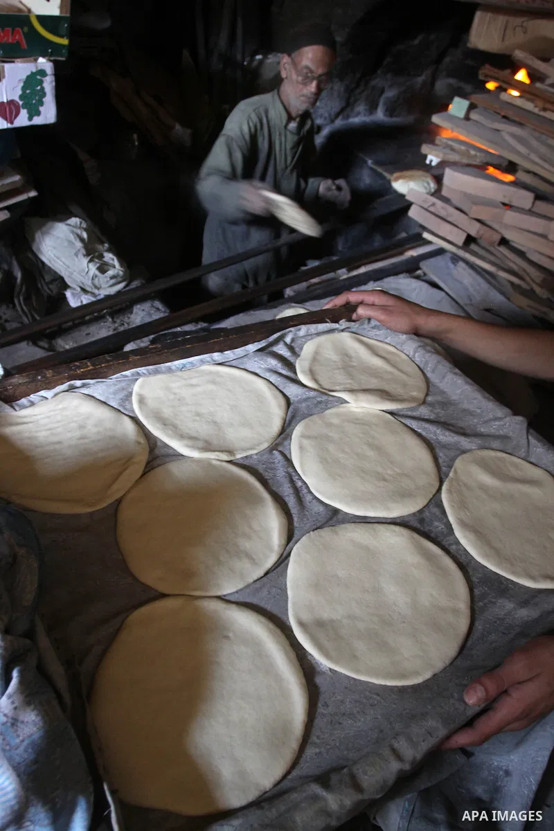 A Palestinian baker prepares loaves of bread at his traditional bakery in Gaza City on Jan. 20, 2011. The flour is running out and there will be a crisis within two days because of Israel's refused to allow some flour to...