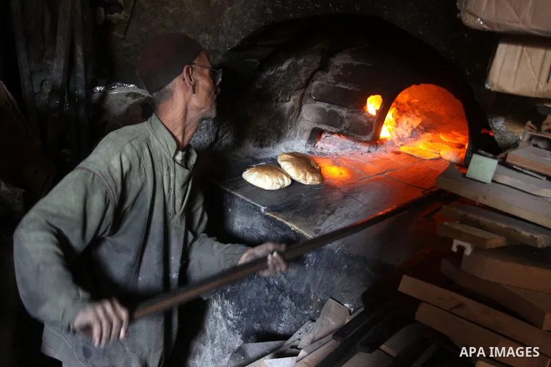 A Palestinian baker prepares loaves of bread at his traditional bakery in Gaza City on Jan. 20, 2011. The flour is running out and there will be a crisis within two days because of Israel's refused to allow some flour to...