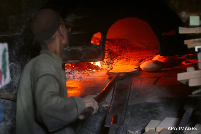 A Palestinian baker prepares loaves of bread at his traditional bakery in Gaza City on Jan. 20, 2011. The flour is running out and there will be a crisis within two days because of Israel's refused to allow some flour to...