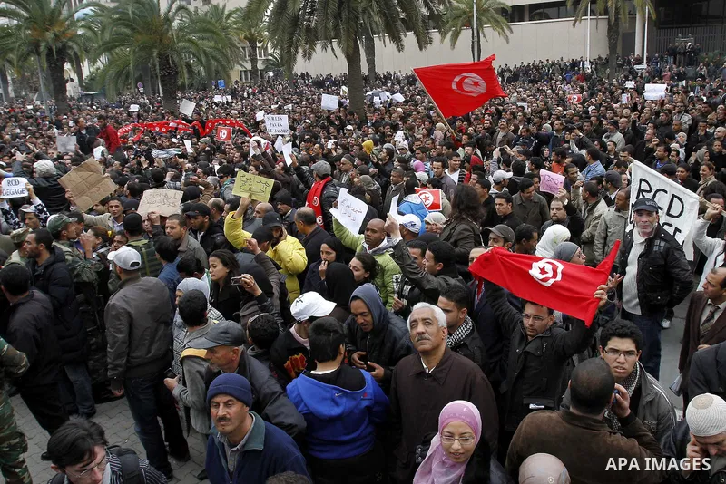 Tunisians take part in a protest in front of the headquarters of the Constitutional Democratic Rally (RCD) party of ousted president Zine al-Abidine Ben Ali during a demonstration in downtown Tunis, January 20, 2011. Tun...