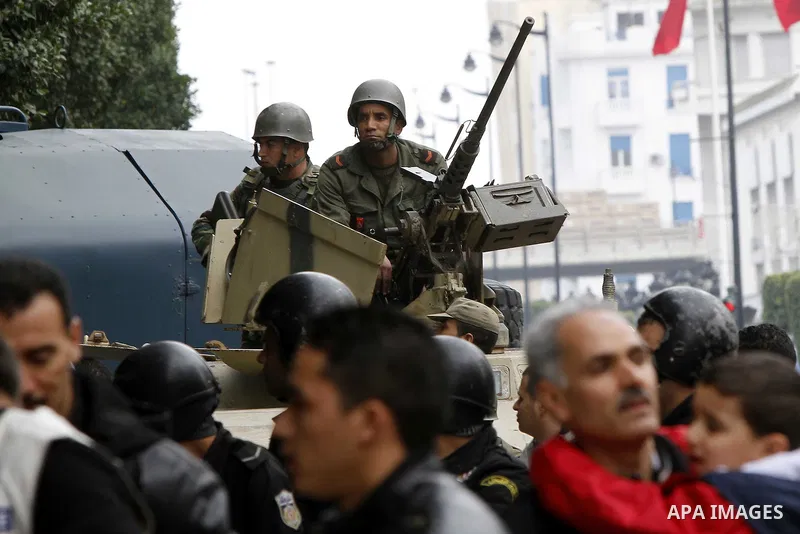 Tunisians take part in a protest in front of the headquarters of the Constitutional Democratic Rally (RCD) party of ousted president Zine al-Abidine Ben Ali during a demonstration in downtown Tunis, January 20, 2011. Tun...