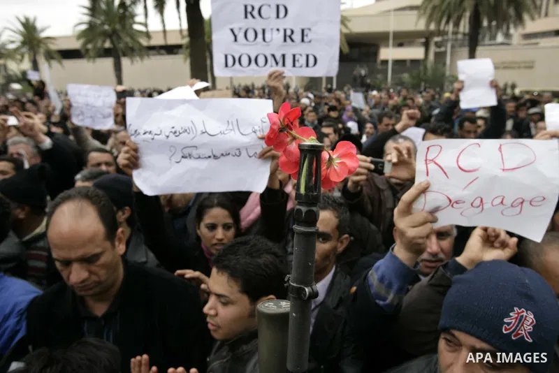 Tunisians take part in a protest in front of the headquarters of the Constitutional Democratic Rally (RCD) party of ousted president Zine al-Abidine Ben Ali during a demonstration in downtown Tunis, January 20, 2011. Tun...