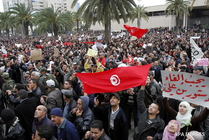Tunisians take part in a protest in front of the headquarters of the Constitutional Democratic Rally (RCD) party of ousted president Zine al-Abidine Ben Ali during a demonstration in downtown Tunis, January 20, 2011. Tun...