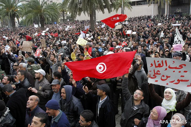 Tunisians take part in a protest in front of the headquarters of the Constitutional Democratic Rally (RCD) party of ousted president Zine al-Abidine Ben Ali during a demonstration in downtown Tunis, January 20, 2011. Tun...