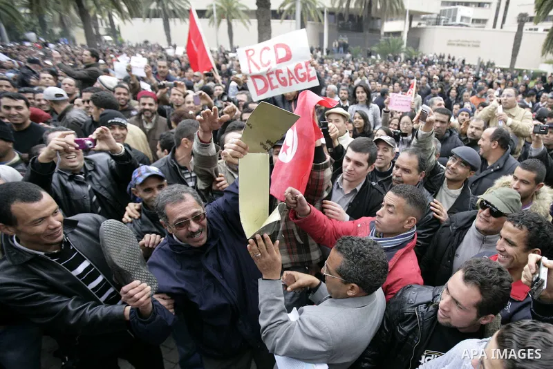 Tunisians take part in a protest in front of the headquarters of the Constitutional Democratic Rally (RCD) party of ousted president Zine al-Abidine Ben Ali during a demonstration in downtown Tunis, January 20, 2011. Tun...