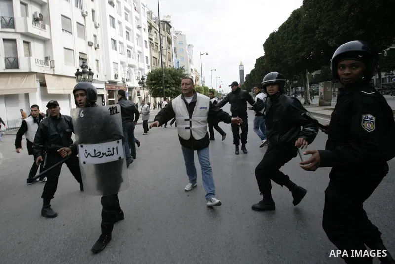 Tunisians take part in a protest in front of the headquarters of the Constitutional Democratic Rally (RCD) party of ousted president Zine al-Abidine Ben Ali during a demonstration in downtown Tunis, January 20, 2011. Tun...