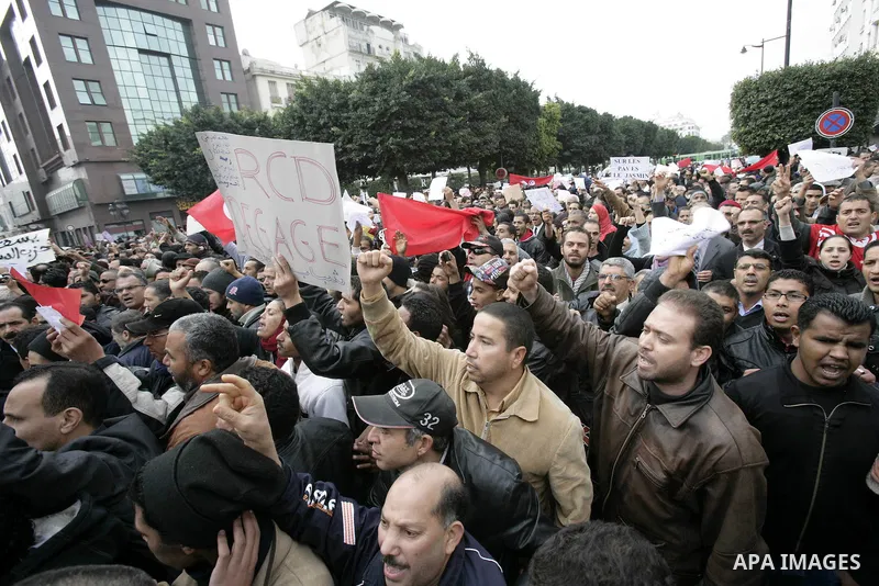 Tunisians take part in a protest in front of the headquarters of the Constitutional Democratic Rally (RCD) party of ousted president Zine al-Abidine Ben Ali during a demonstration in downtown Tunis, January 20, 2011. Tun...