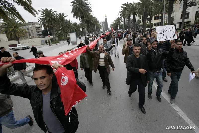 Tunisians take part in a protest in front of the headquarters of the Constitutional Democratic Rally (RCD) party of ousted president Zine al-Abidine Ben Ali during a demonstration in downtown Tunis, January 20, 2011. Tun...