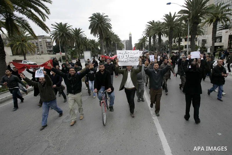 Tunisians take part in a protest in front of the headquarters of the Constitutional Democratic Rally (RCD) party of ousted president Zine al-Abidine Ben Ali during a demonstration in downtown Tunis, January 20, 2011. Tun...