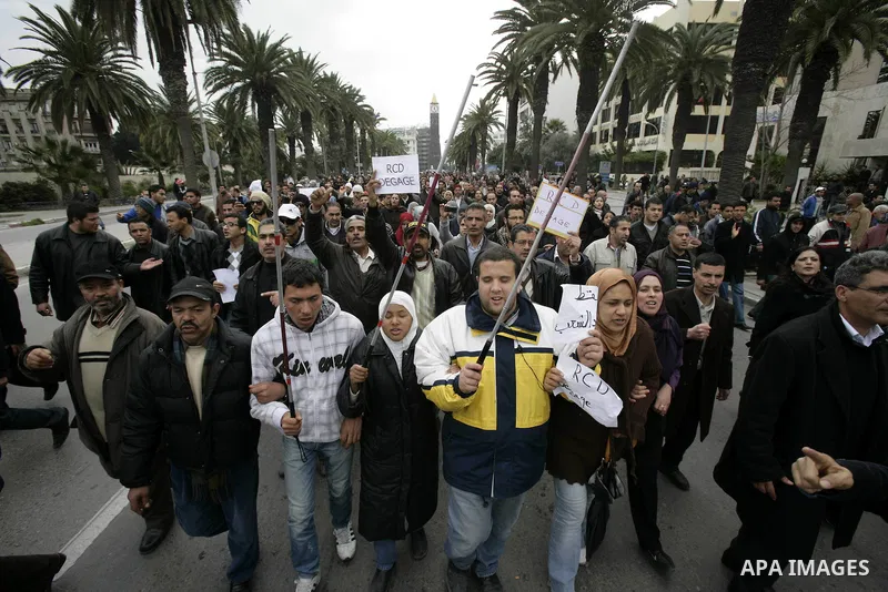 Tunisians take part in a protest in front of the headquarters of the Constitutional Democratic Rally (RCD) party of ousted president Zine al-Abidine Ben Ali during a demonstration in downtown Tunis, January 20, 2011. Tun...