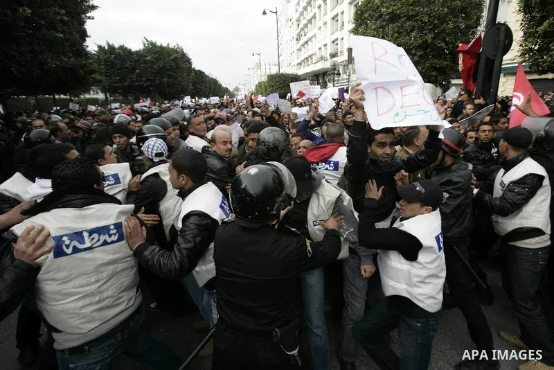 Tunisians take part in a protest in front of the headquarters of the Constitutional Democratic Rally (RCD) party of ousted president Zine al-Abidine Ben Ali during a demonstration in downtown Tunis, January 20, 2011. Tun...