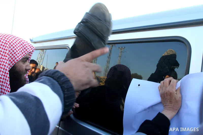 Palestinian relatives of a prisoners jailed in Israel hold posters as they block the vehicle carrying French Foreign Minister Michele Alliot-Marie as it makes its way into Gaza Strip, on the Palestinian side of the Erez...