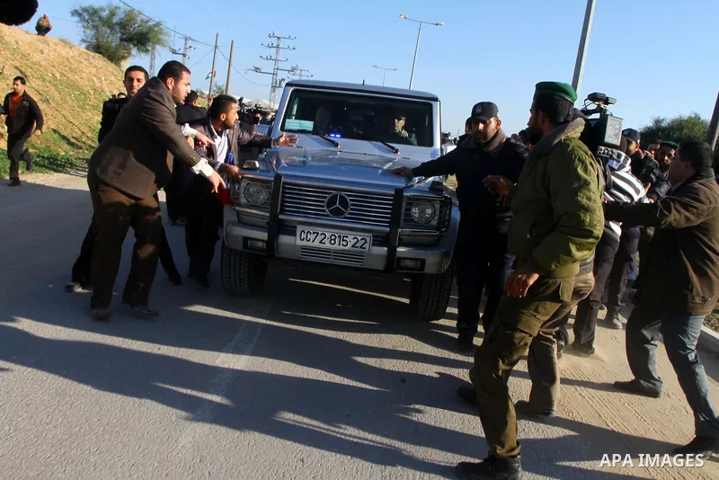 Palestinian security officers open the road as Palestinian relatives of a prisoners jailed in Israel block the vehicle carrying French Foreign Minister Michele Alliot-Marie as it makes its way into Gaza Strip, on the Pal...