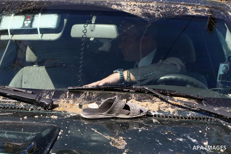 A shoe rests on the bonnet of a car belonging to the entourage of French Foreign Minister Michele Alliot-Marie during her visit to Al-Quds hospital in Gaza City, on Jan. 21, 2011. A crowd of furious Palestinian protester...