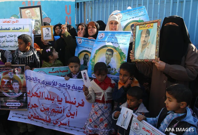 Relatives of Palestinians being held in Israeli jails hold pictures of them as French Foreign Minister Michele Alliot-Marie visits U.N. headquarters in Gaza City, on Jan. 21, 2011. A crowd of furious Palestinian proteste...