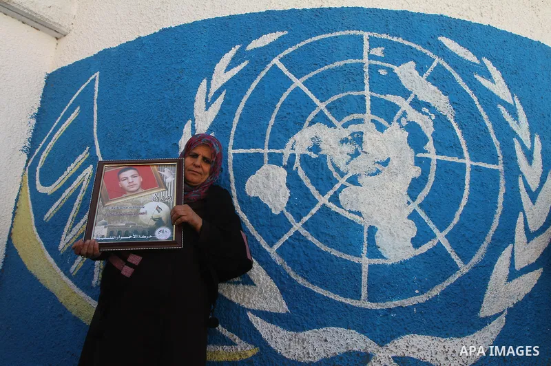 Relatives of Palestinians being held in Israeli jails hold pictures of them as French Foreign Minister Michele Alliot-Marie visits U.N. headquarters in Gaza City, on Jan. 21, 2011. A crowd of furious Palestinian proteste...