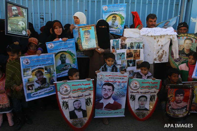 Relatives of Palestinians being held in Israeli jails hold pictures of them as French Foreign Minister Michele Alliot-Marie visits U.N. headquarters in Gaza City, on Jan. 21, 2011. A crowd of furious Palestinian proteste...