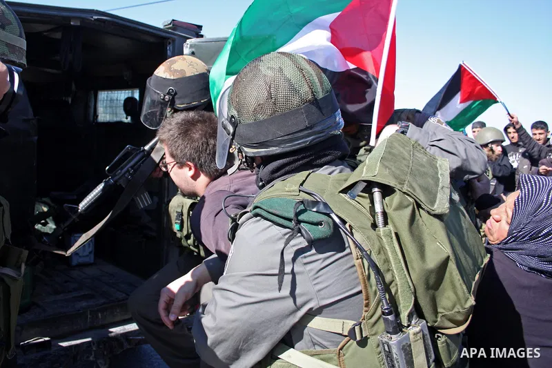 Israeli soldiers arrest a demonstrator during a protest against Israel's controversial separation barrier in the West Bank village of Maasarah, near Bethlehem, on January 21, 2011. Israel says the network of steel and co...