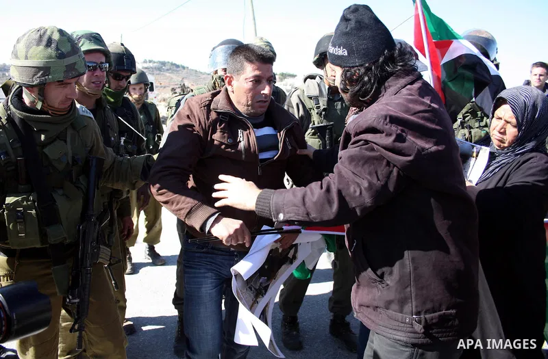 Israeli soldiers arrest a demonstrator during a protest against Israel's controversial separation barrier in the West Bank village of Maasarah, near Bethlehem, on January 21, 2011. Israel says the network of steel and co...